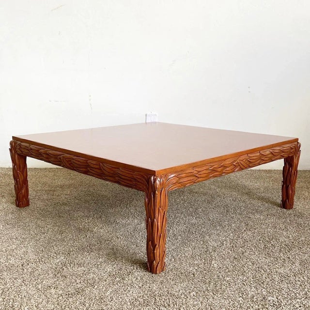 Amazing vintage hand carved wooden coffee table. Features a design of leaves throughout the legs and frame of the table.