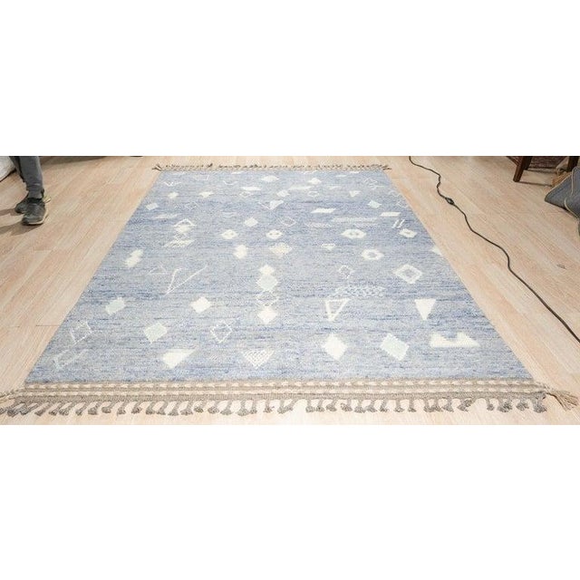 This blue hand knotted pile rug is crafted from wool and features a traditional Berber carpet style. Produced in Pakistan,...