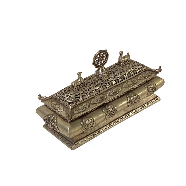 The Chinese Tibetan Silver Color Rectangular Shape Incense Burner is a traditional Tibetan-style incense holder. It is...