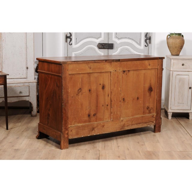 An Italian walnut buffet from the 19th century with two drawers over two doors, carved diamonds and floral motifs. This...