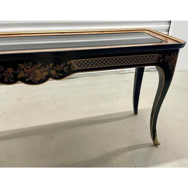 Hard to find lacquered, hand painted chinoiserie two drawer console table with glass insert . The table legs have brass...