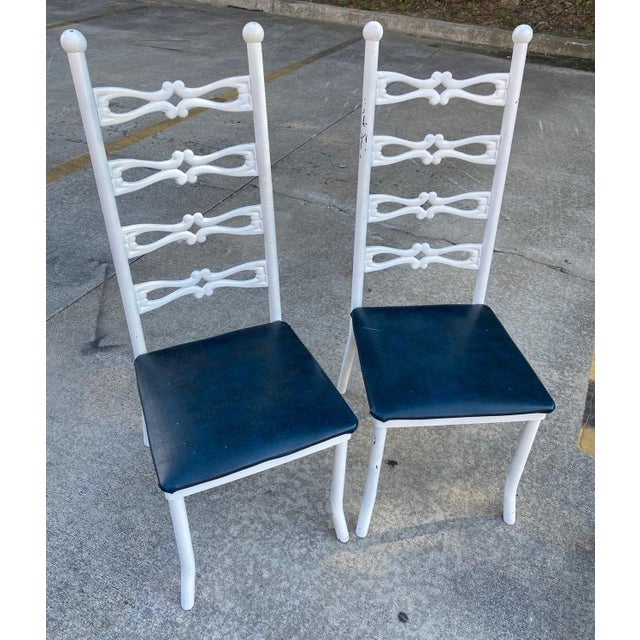 Up for consideration is a beautiful vintage pair of Italian style white metal chairs with navy leather cushions. These...