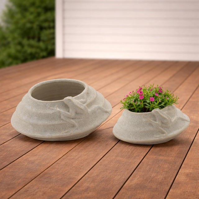 Bring a playful touch to your space with the Round Porcelain Planter with Frog Set. Featuring cool beige and white tones...