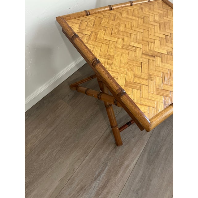 This is a vintage 1970s handcrafted bamboo serving folding table with a herringbone pattern top and X-base. The table...