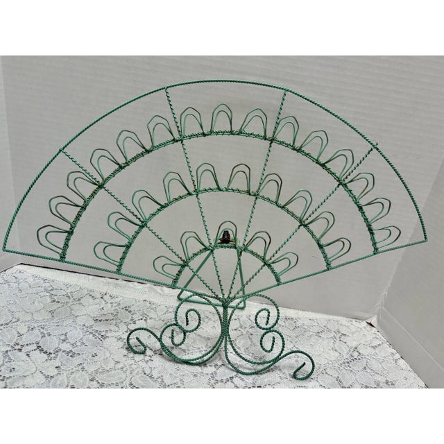 Vintage rustic bohemian turquoise photo holder with an arched shape and capacity to hold up to thirty photos or notes....
