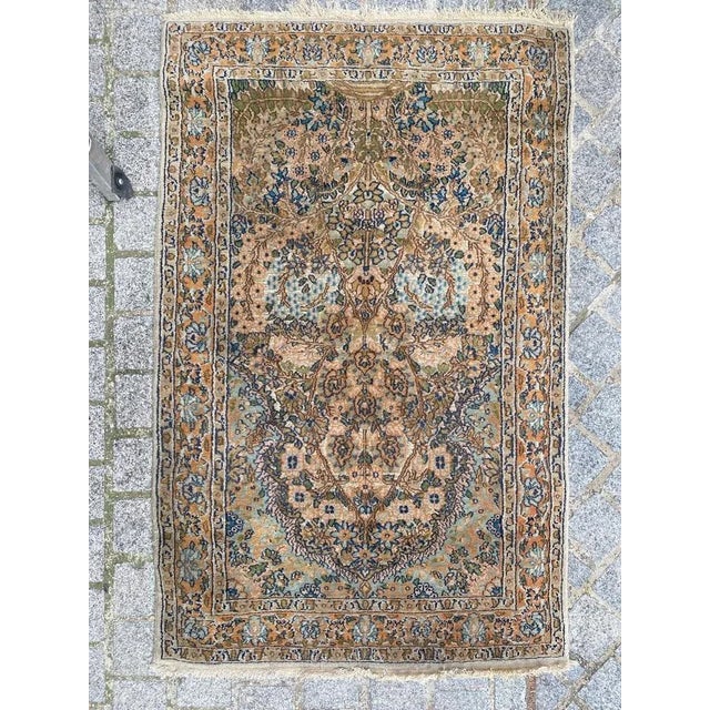 Beautiful small vintage rug from Punjab, India. This exquisite piece features a floral design meticulously hand-knotted...