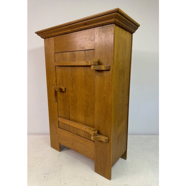 This captivating cabinet is a fine example of 1960s Belgian oak craftsmanship, designed in a distinctive Brutalist style....