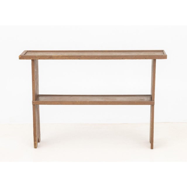 American Brown Painted Two-Tier Console Table. 27" H x 40.5" W x 9.5" D. Provenance: From a 21 East 87th Street Estate.