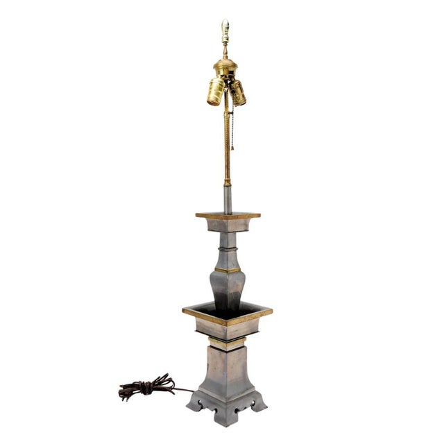 A vintage pair of pewter table lamps with brass accents, Asian inspired. The chinoiserie influenced lamps feature an...