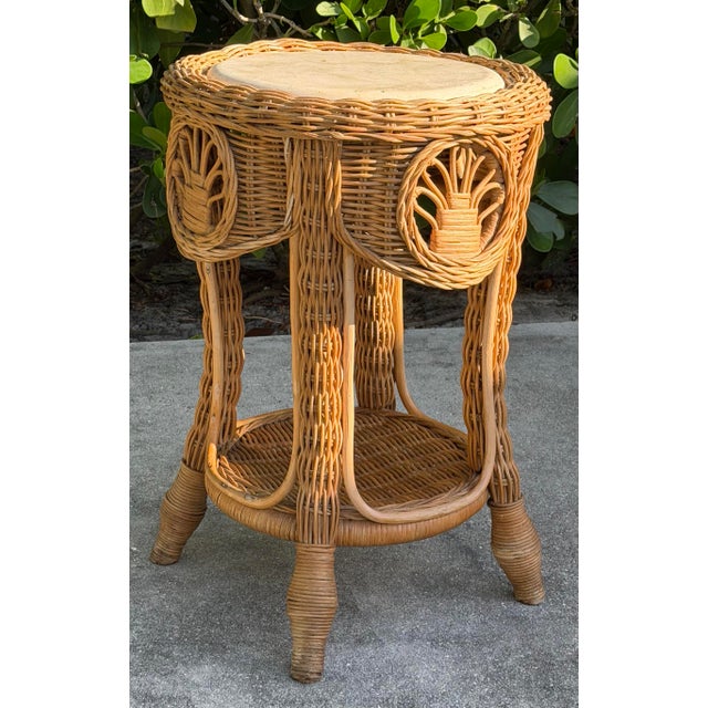 Vintage rattan side table with woven construction, decorative rattan panels, wrapped legs, lower shelf, and a round...