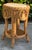 Vintage rattan side table with woven construction, decorative rattan panels, wrapped legs, lower shelf, and a round...