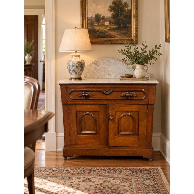 Bring timeless Victorian elegance into your home with this beautifully preserved Eastlake marble-top washstand dating to...