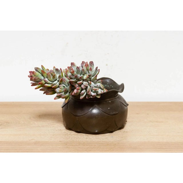 A beautiful Japanese rounded vessel made from bronze and features and aged brown patina with a beautiful open lotus flower...