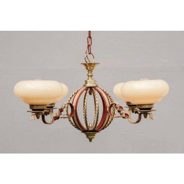Chandelier in Art Deco style, made (probably in France) in 1930s/40s. Ivory opal glass shades on forged iron body with...