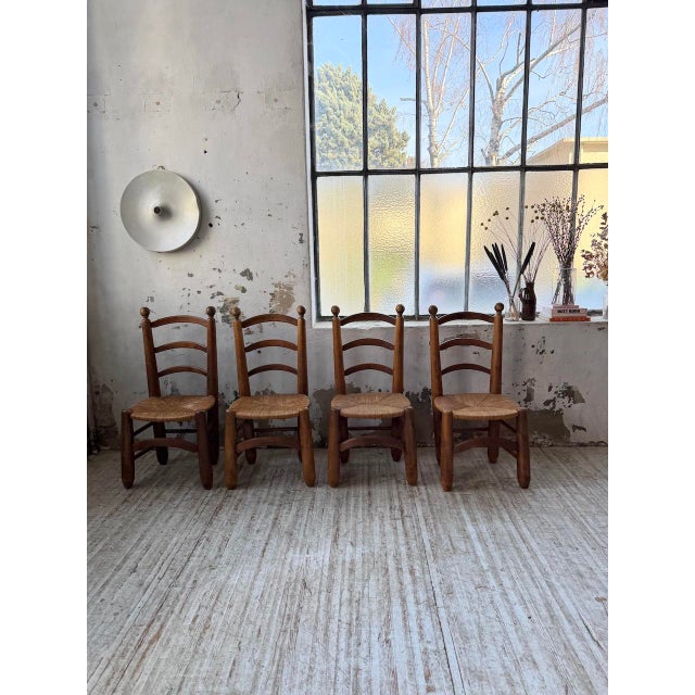 Set of four solid oak chairs with straw seats, attributed to Charles Dudouyt, dating from the 1940s. We love their rustic...