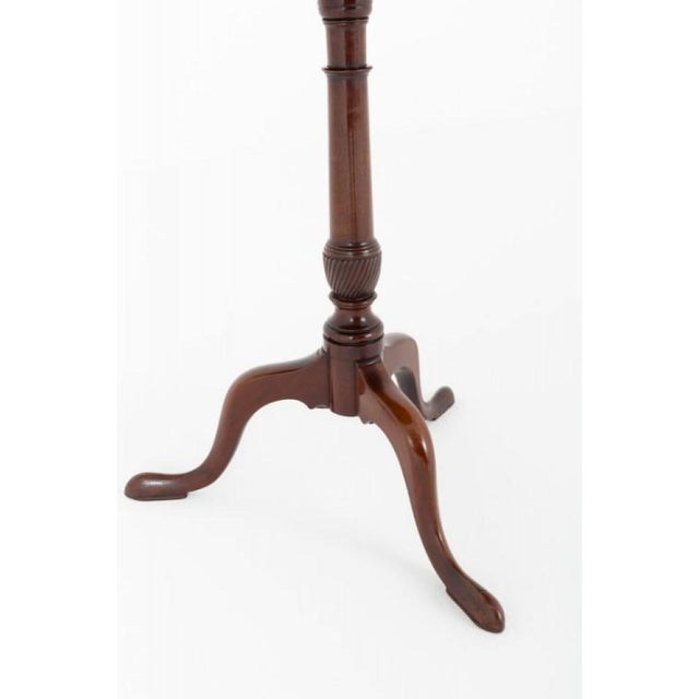 Georgian mahogany wine table. Circa 1800 This wine table stands upon swept legs with pad feet and a turned and fluted...