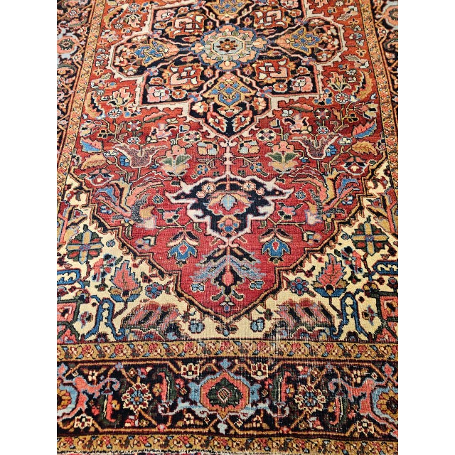 "A visually captivating Persian Heriz room size rug from the first quarter of the 20th century. Set against a rich...