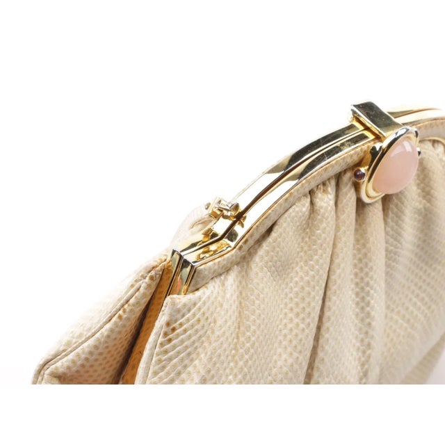 An early lovely sophisticated Judith Leiber cream karung snakeskin purse. The bag is styled with a gold tone hinged frame...