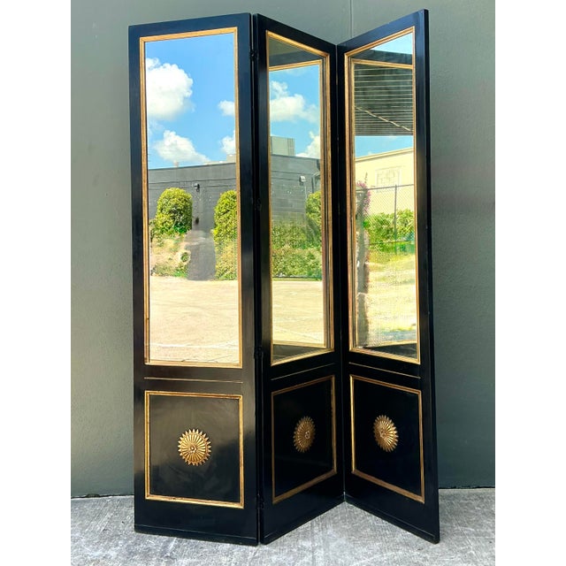 This stunning vintage three-panel folding screen is a masterwork of Neoclassical elegance and Hollywood Regency glamour....