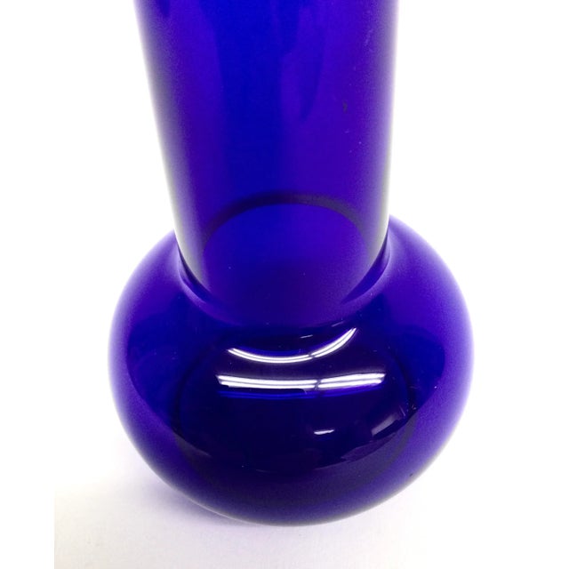Super bright cobalt blue glass has been hand blown by artisans to create this work of art. The perfect size for one flower...