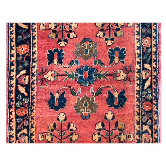 A sweet early 20th century Persian Sarouk rug with a simple but beautiful mirrored floral pattern woven in indigo, brown,...