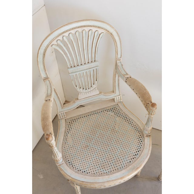 A refined and elegant Set of 6 Louis XVI Dining Chairs, including two armchairs and four side chairs, showcasing the...