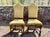 A set of six Jacobean style carved walnut dining side chairs with a barley twist stretchers, scalloped apron, sculpted...