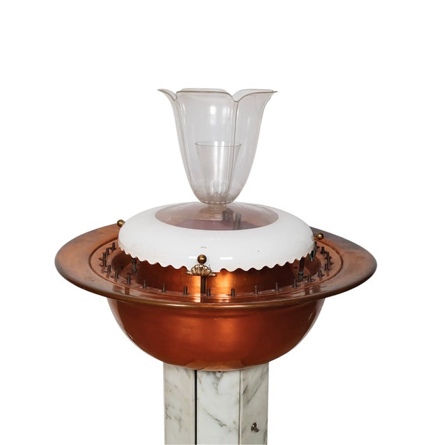 Illuminated marble and copper fountain.