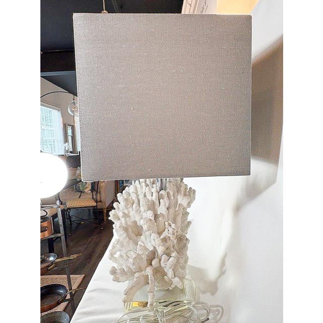 This unique table lamp by Regina Andrew features a sculptural faux white coral body, adding a coastal or organic touch to...