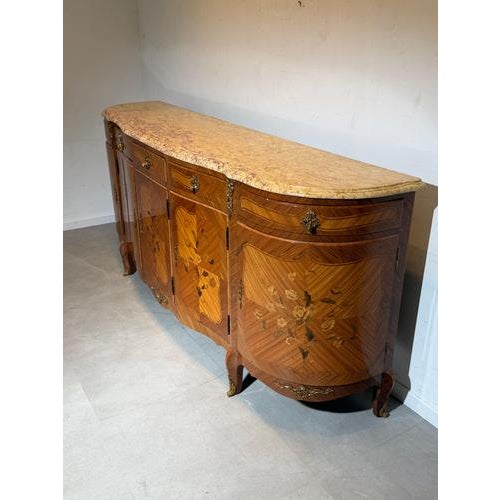 Elegant and impressive Louis XV sideboard featuring beautiful floral marquetry inlay and a warm walnut veneer. The façade...