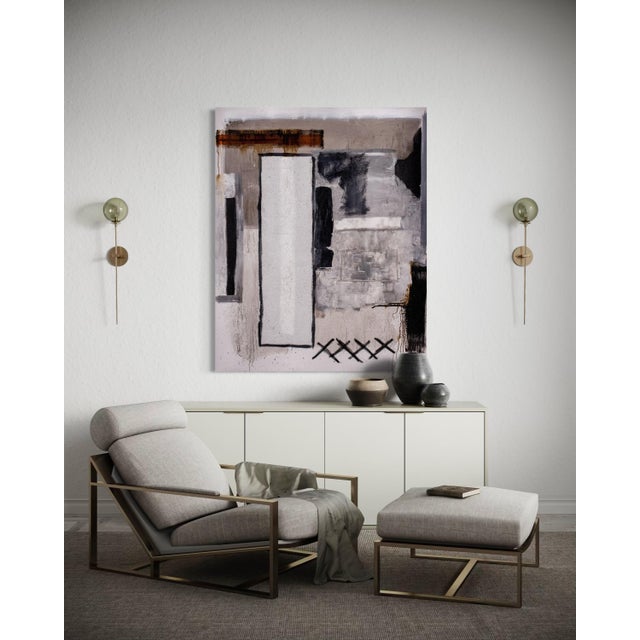 Inequity by J. Kent Martin presents a refined interplay of neutral tones—soft taupe, chalk white, charcoal, and warm...