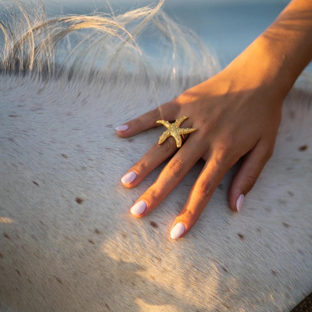 Bring the magic of the ocean to your style with the Ocean Spirit Starfish Gold Adjustable Ring. Inspired by the beauty and...