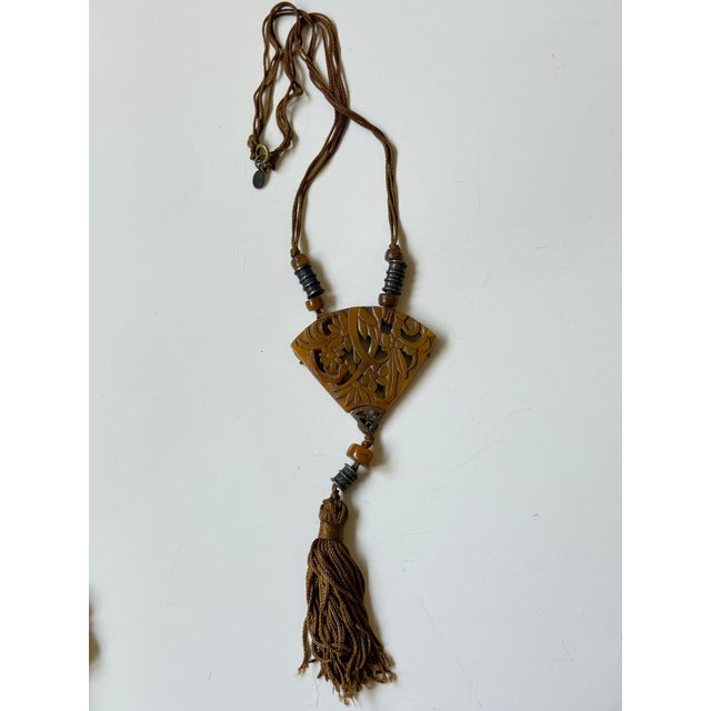 Wonderful vintage Alice Caviness fan shaped chinoiserie necklace featuring carved amber colored celluloid and (most...