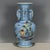 A beautiful Chinese porcelain vase featuring a light blue glazed ground with a subtle incised wave pattern. The vase has a...