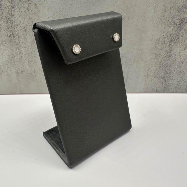 These elegant Mother of Pearl & Diamond Studs in 14kt yellow gold feature approx. 0.10ctw of natural GH SI round single-...