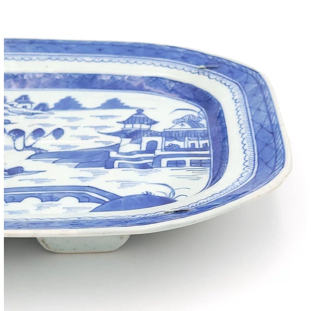 A Canton well and tree platter, China circa 1860. Old staple restoration to underside.