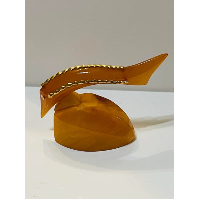 Enhance your collection with this stunning vintage Soviet Baltic Amber Fish Figurine. The Egg Yolk color and gold accents...