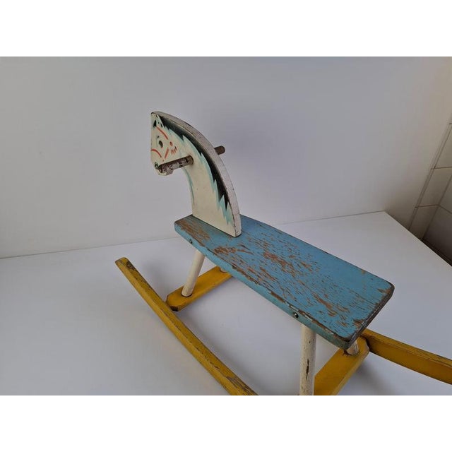 This mid-century wooden rocking horse, crafted in 1960s Czechoslovakia, displays the playful yet artisanal qualities...