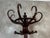 An elegant coat rack, dating from the 1920s, crafted from bent beechwood stained in a deep mahogany hue. This iconic piece...