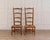 A charming pair of 19th-century French Provençal nurse’s chairs, distinguished by their notably low seats, a form...