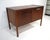 A very well crafted walnut smaller sized credenza with a small upper divided drawer and larger file styed drawer and to...