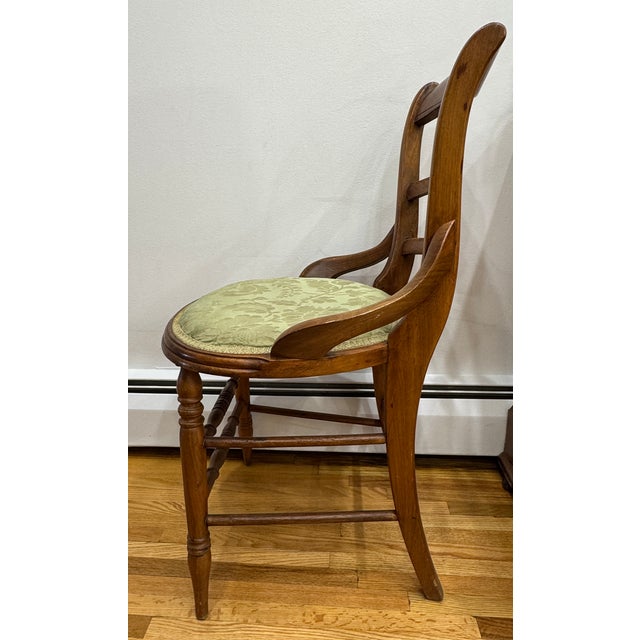 Beautiful vintage ladder-back chair featuring elegant carved rose decoration on the crest rail. Solid wood construction...