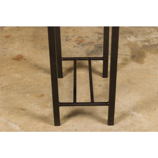 A small side table with Louis Vuitton leather top mounted on a custom metal base with cross stretchers. Immerse yourself...