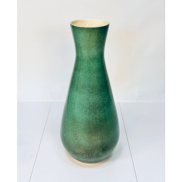 A large elegant floor vase, handcrafted in Italy during the 1950s, glazed in turquoise and a soft yellow on the inside....