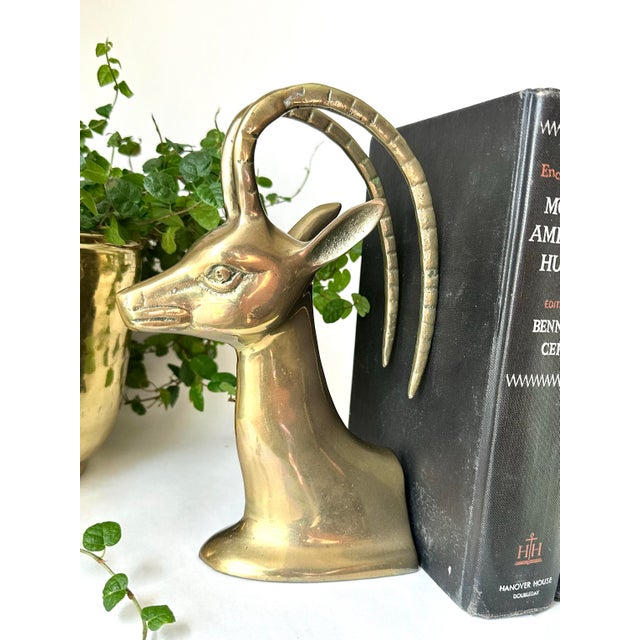 Stunning pair of vintage solid brass gazelle (ibex/antelope) bookends featuring a polished gold finish and elegant...