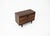 Wooden sideboard with two drawers and two doors, containing a glass shelf, by Renato Magri. Signs of wear consistent with...