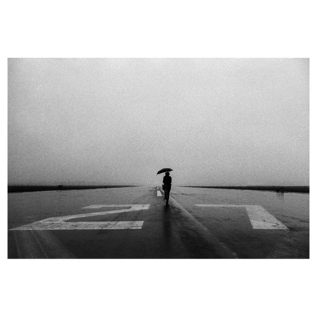 Tim Bieber, Lone Person With Umbrella in the Rain on Runway, Photographic Paper For Sale
