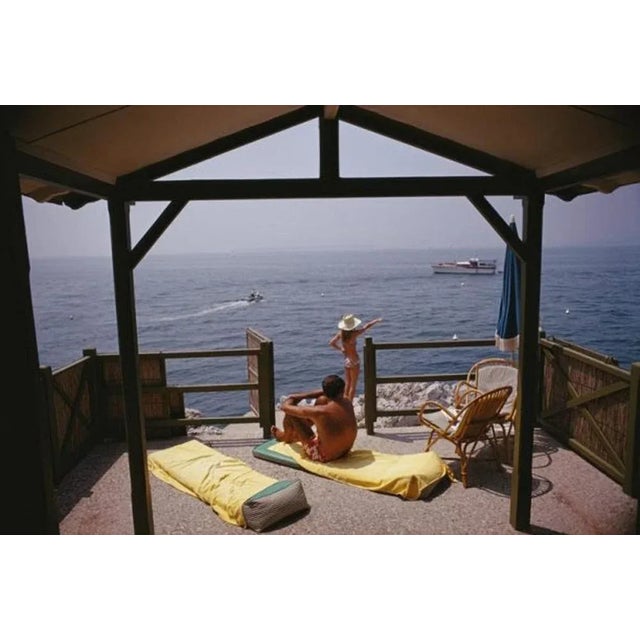 Beach Hut In Antibes 1969 by Slim Aarons Slim Aarons Limited Estate Edition Guests at a beach hut at the Hotel du Cap-...