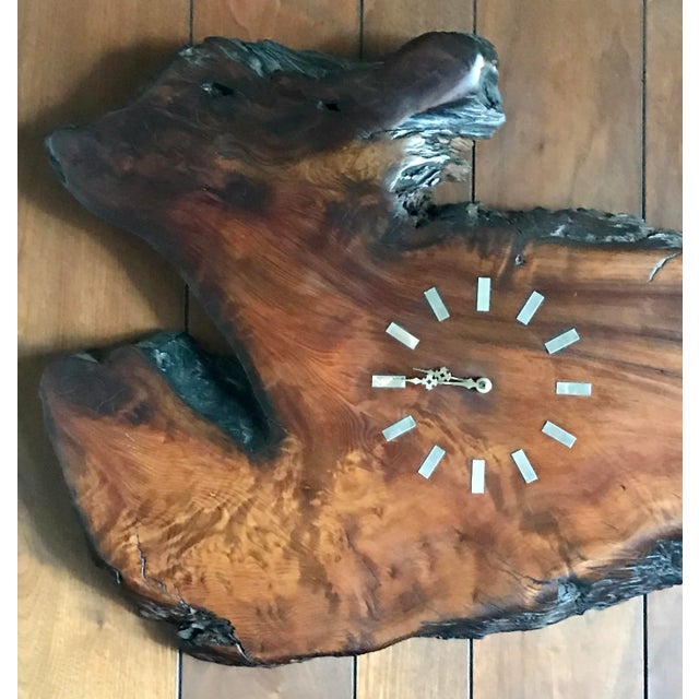 This is a magnificent live edge wood sculpture that has both a mirror and a clock! It has such an amazing movement to it!...