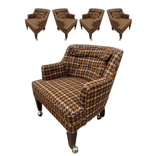 A matched set of four vintage mid-century club chairs, upholstered in a bold, multi-tonal houndstooth-plaid weave in burnt...